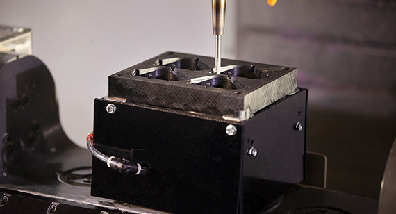 An endmill machines an enclosure.