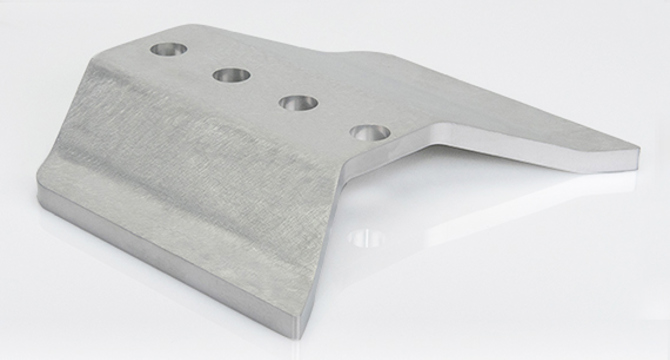 Silver metal part on white table