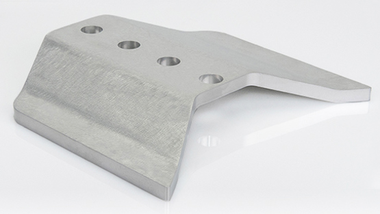 Silver metal part on white table