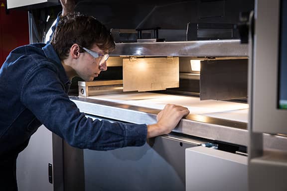 engineer looking into 3D Printer machine