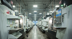A row of CNC mills at Protolabs