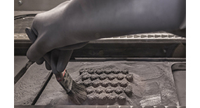 Technician brushes away powder